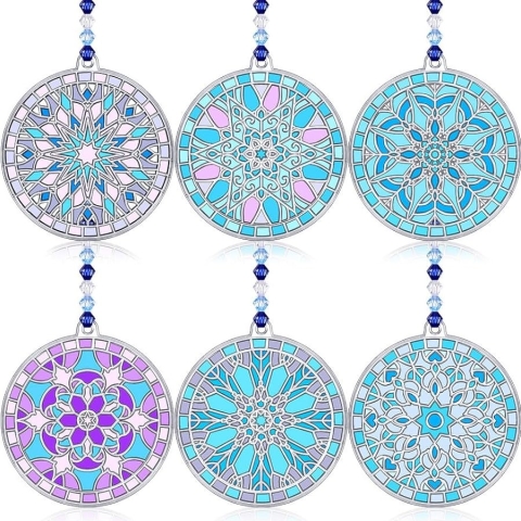 Six decorative suncatchers with snowflake inspired designs, painted in a variety of colors.