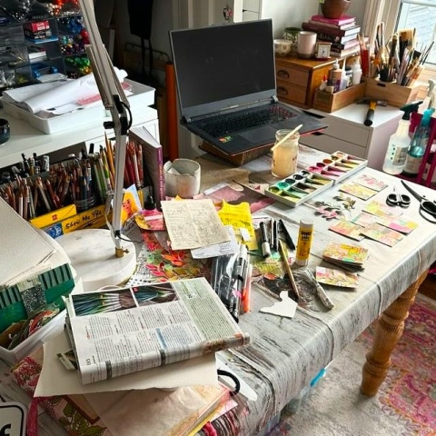 A collection of various arts and crafts tools spread out across a table.