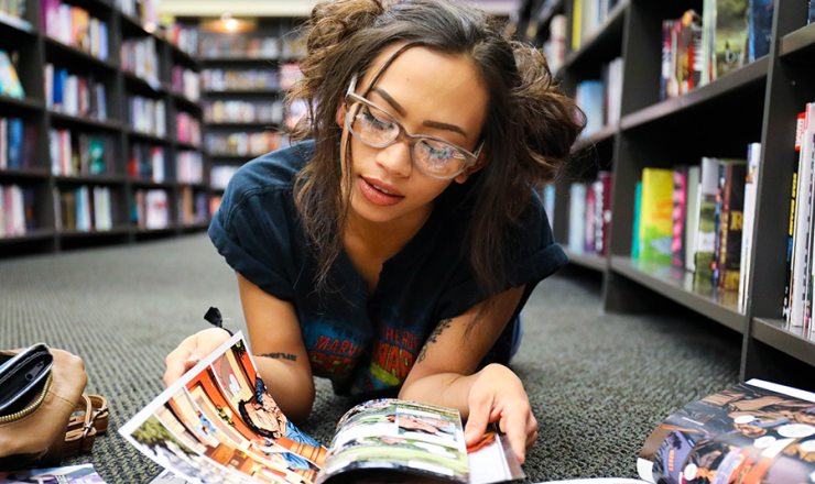 Teen girl flipping through graphic novels